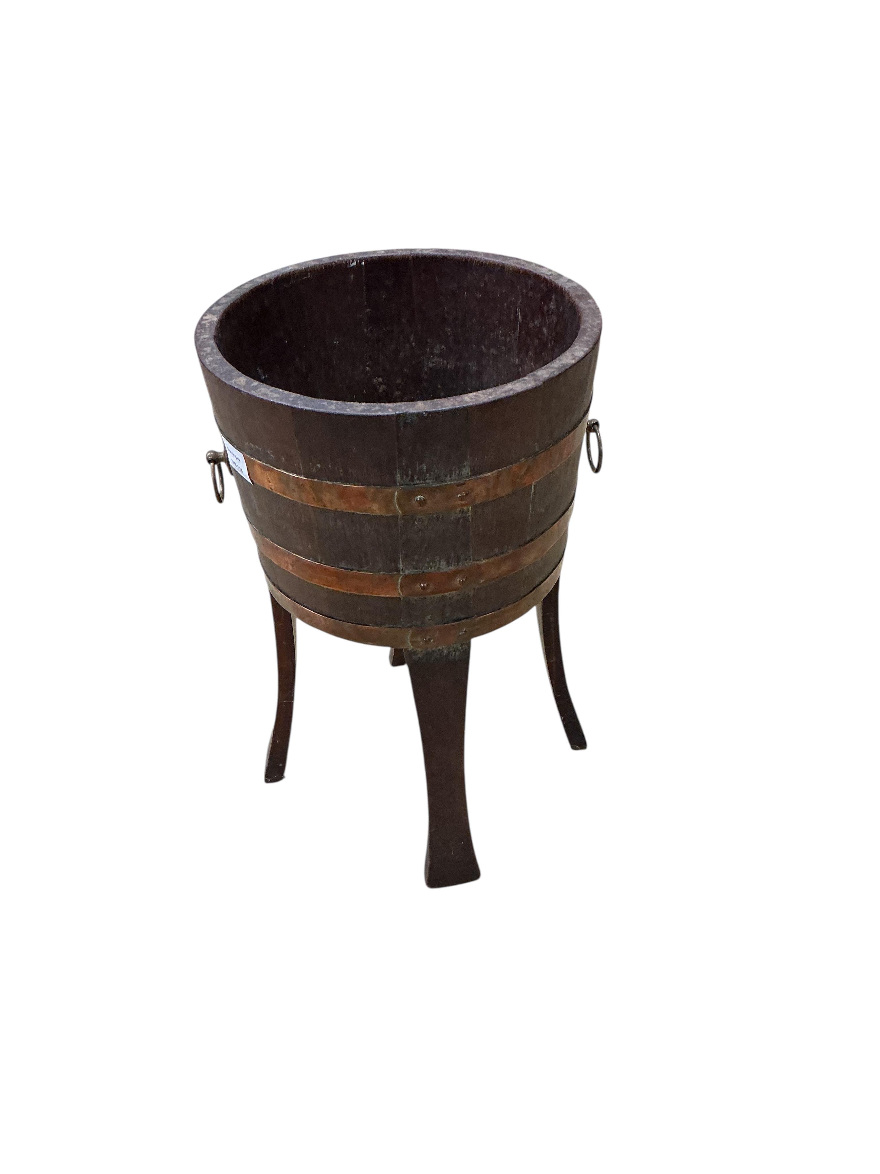 A copper bound staved oak circular jardiniere, late 19th century, maker's stamp Champion RD, diameter 33cm, height 53cm
